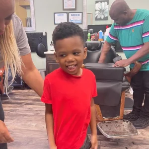 a kid happy after his haircut