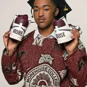 learner holding a shoe in each hand near his face