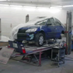 blue car in Jd's Auto Body & Painting's workshop