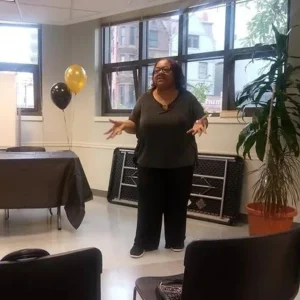 Bulinda standing with her arms stretched out