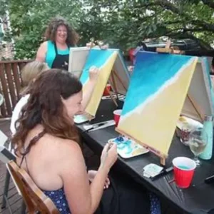 people painting on canvases