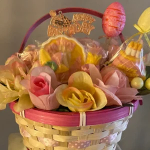 a basket of floral and sweets arrangement 